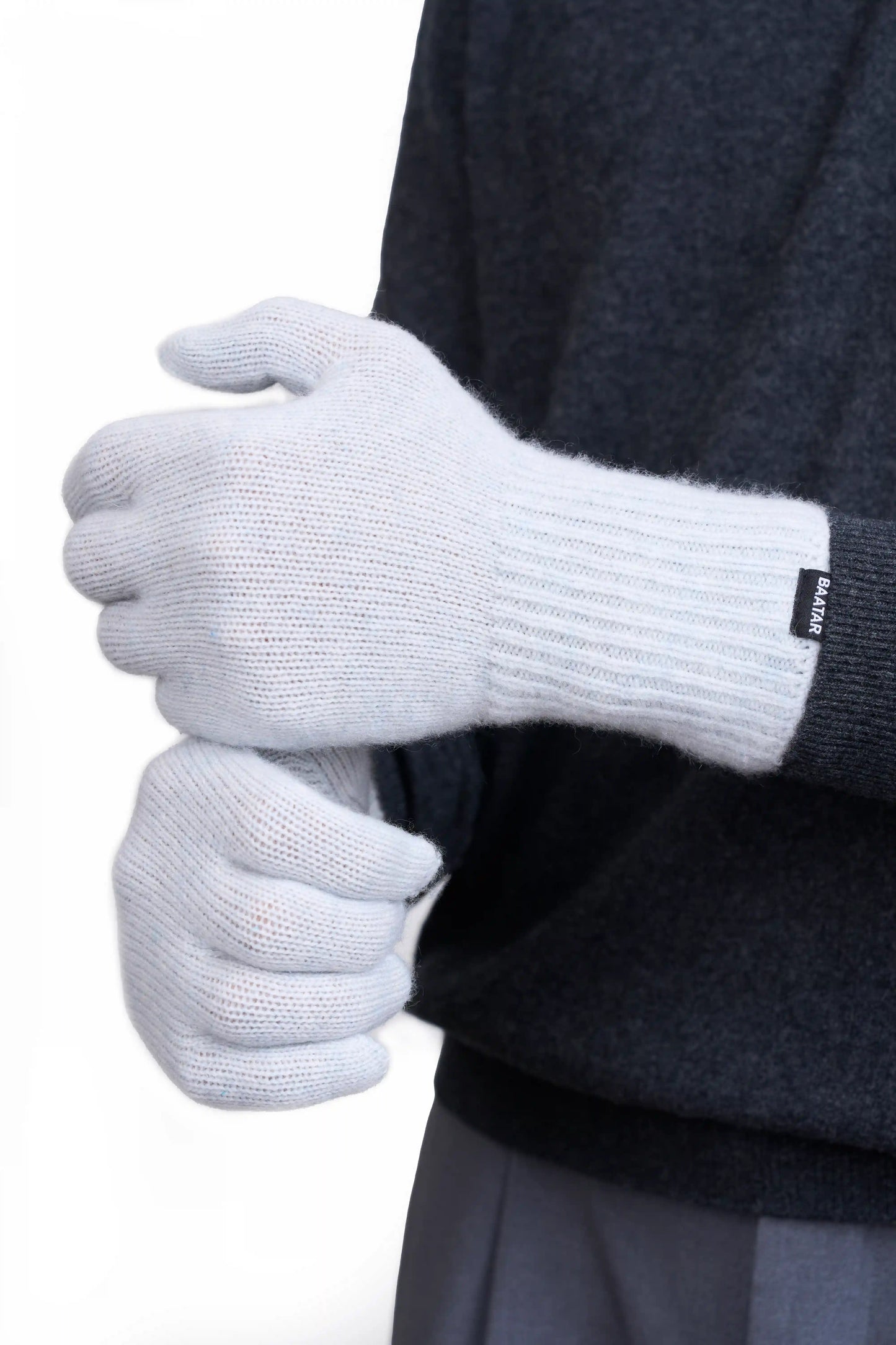 Soft and warm Mongolian cashmere gloves in light gray, worn by a male Mongolian model wearing a gray sweater