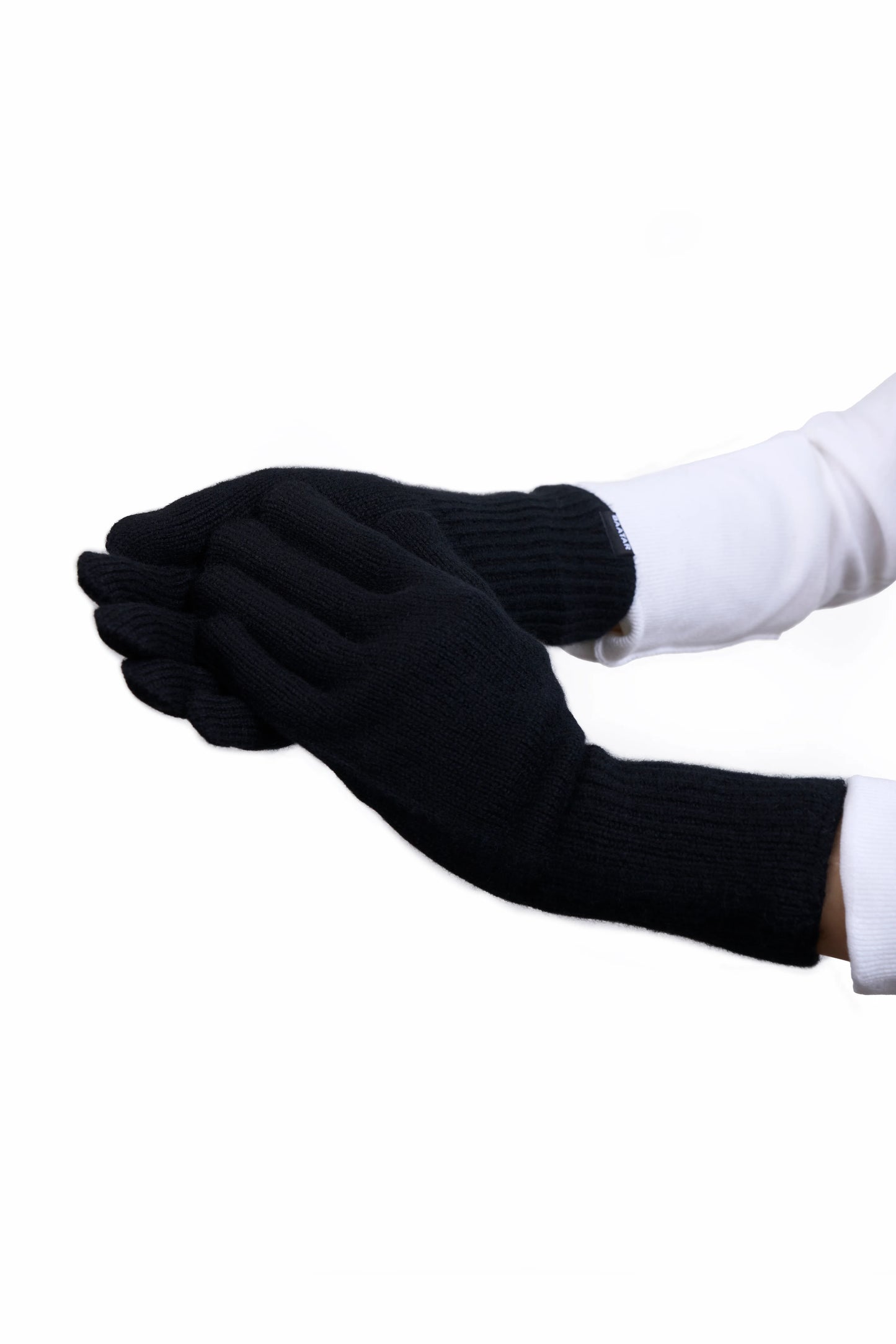 Soft and warm Mongolian cashmere gloves in black, worn by a female Mongolian model wearing a white sweater