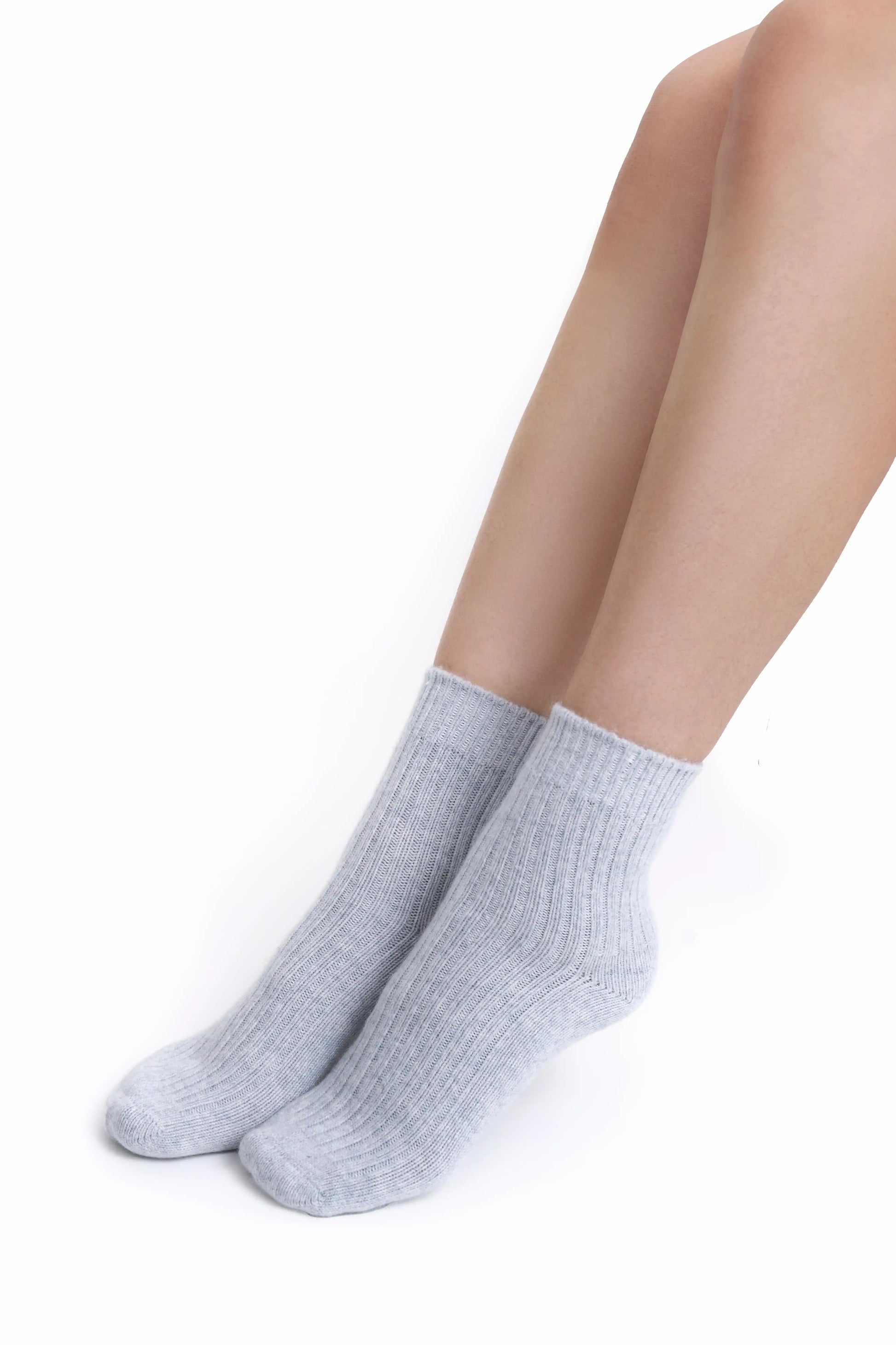 A close-up of premium gray Mongolian cashmere socks worn by a female Mongolian model, highlighting their fine knit and elegant design.