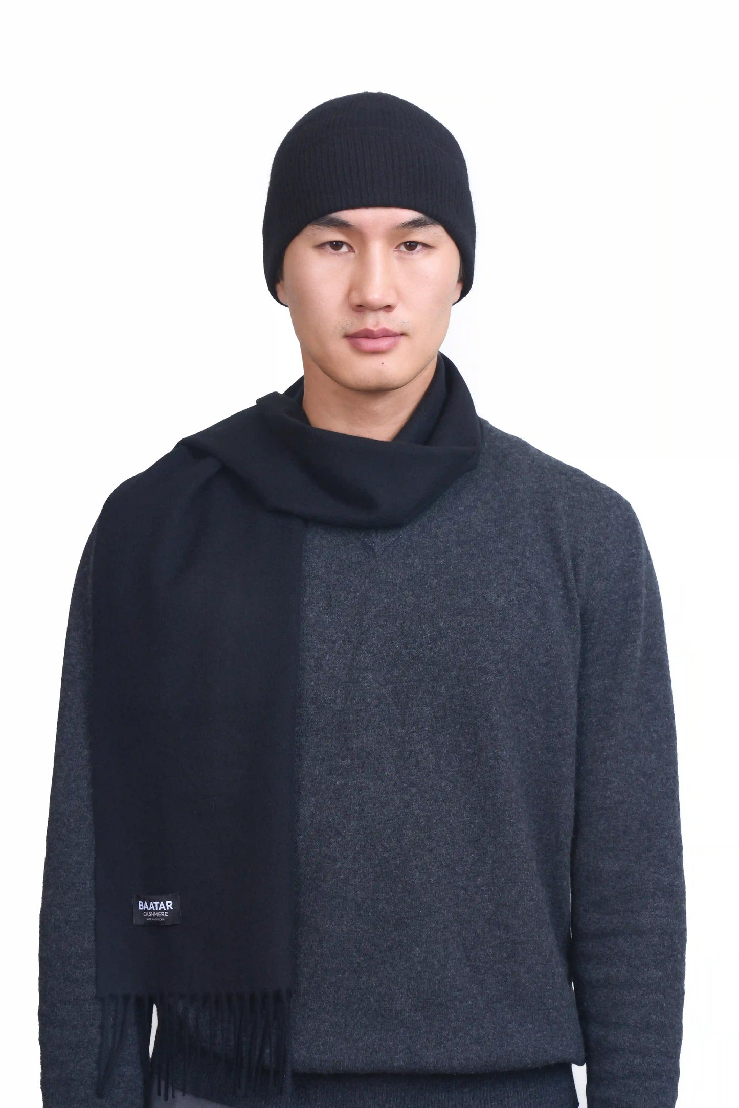 Luxurious charcoal gray Mongolian cashmere scarf and beanie worn on a male Mongolian model, lightweight and cozy, perfect for winter layering