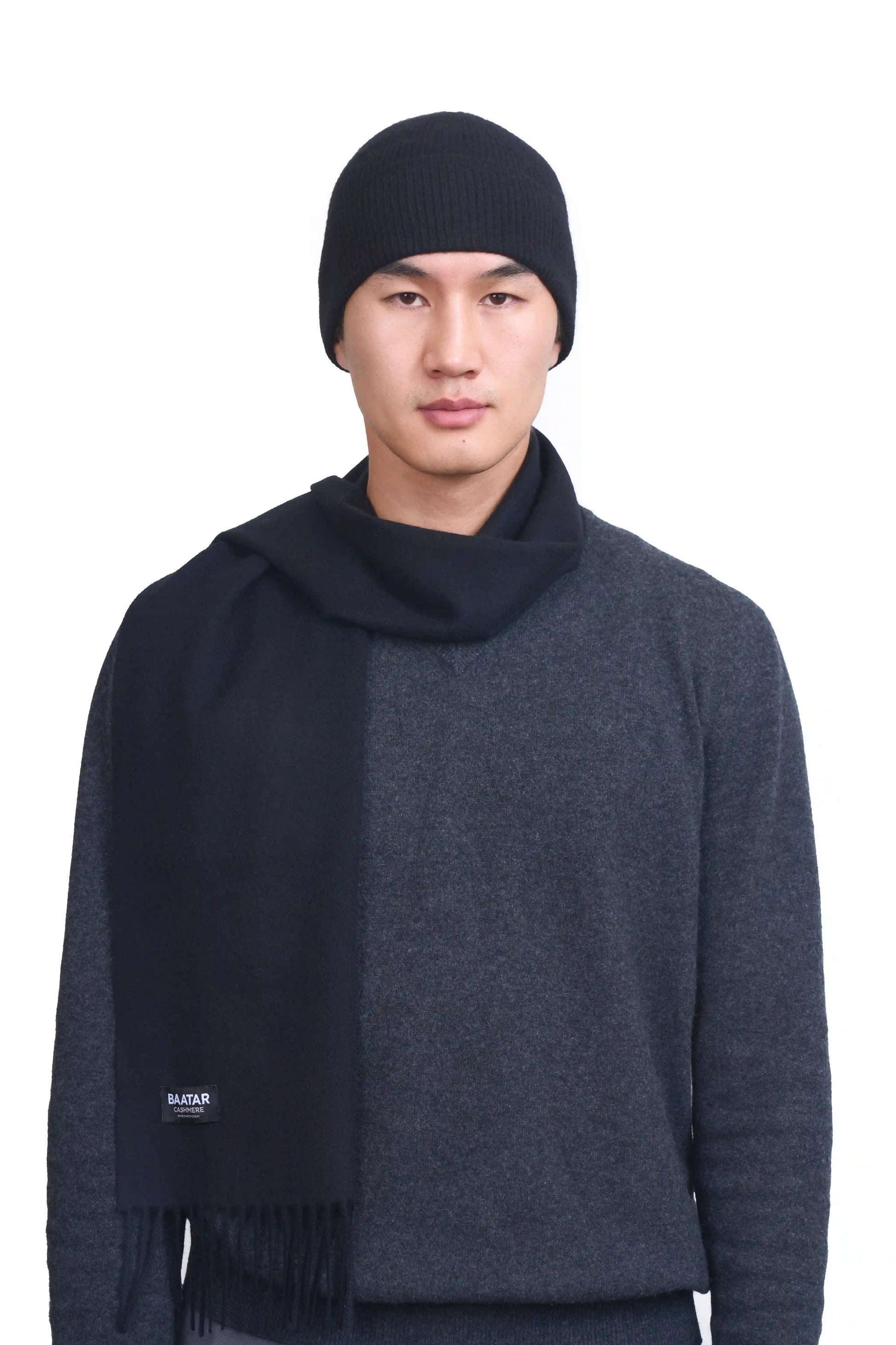 Luxurious charcoal gray Mongolian cashmere scarf and beanie worn on a male Mongolian model, lightweight and cozy, perfect for winter layering