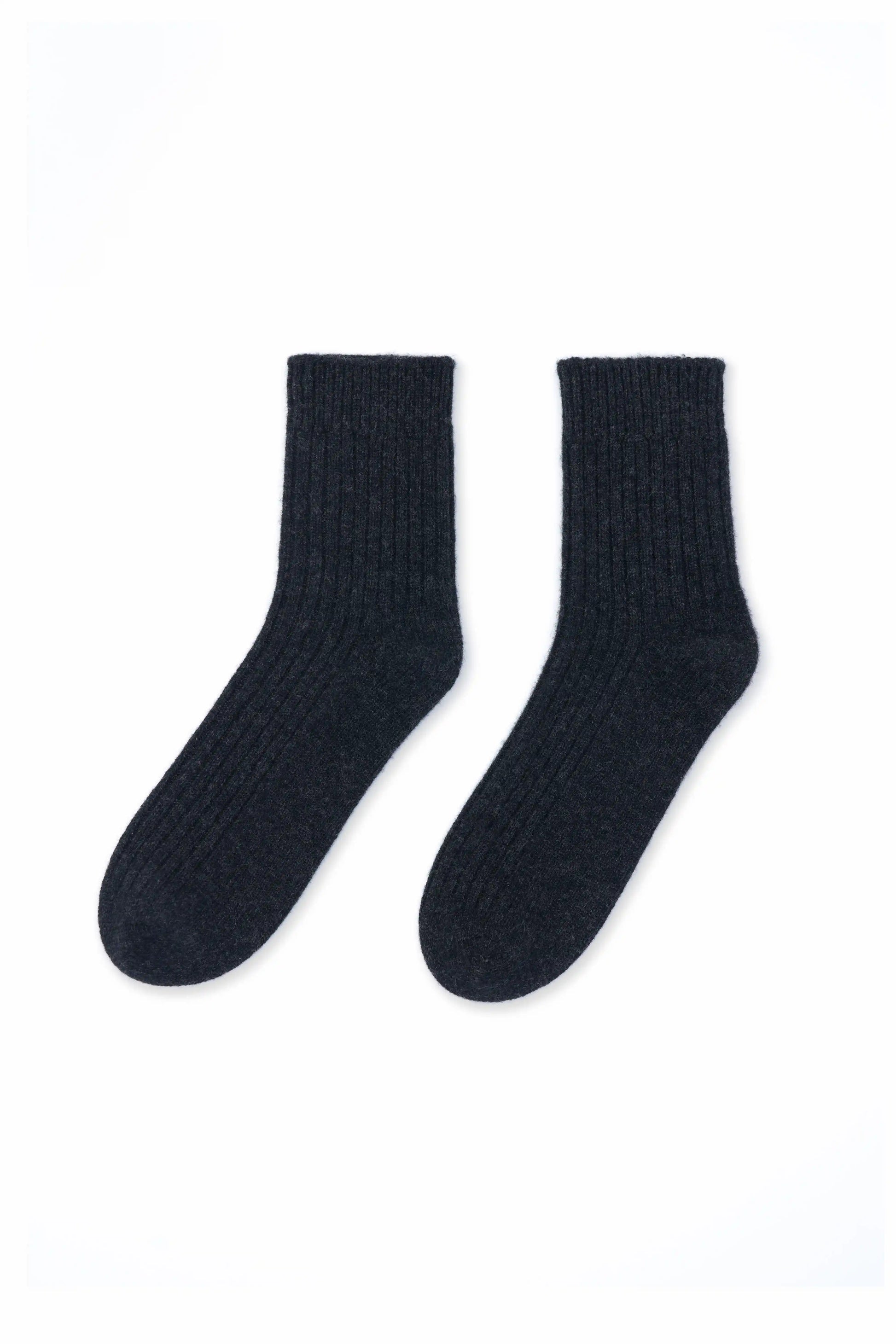 Cozy and soft charcoal Mongolian cashmere socks laid flat on a white background, showcasing their luxurious texture and warmth