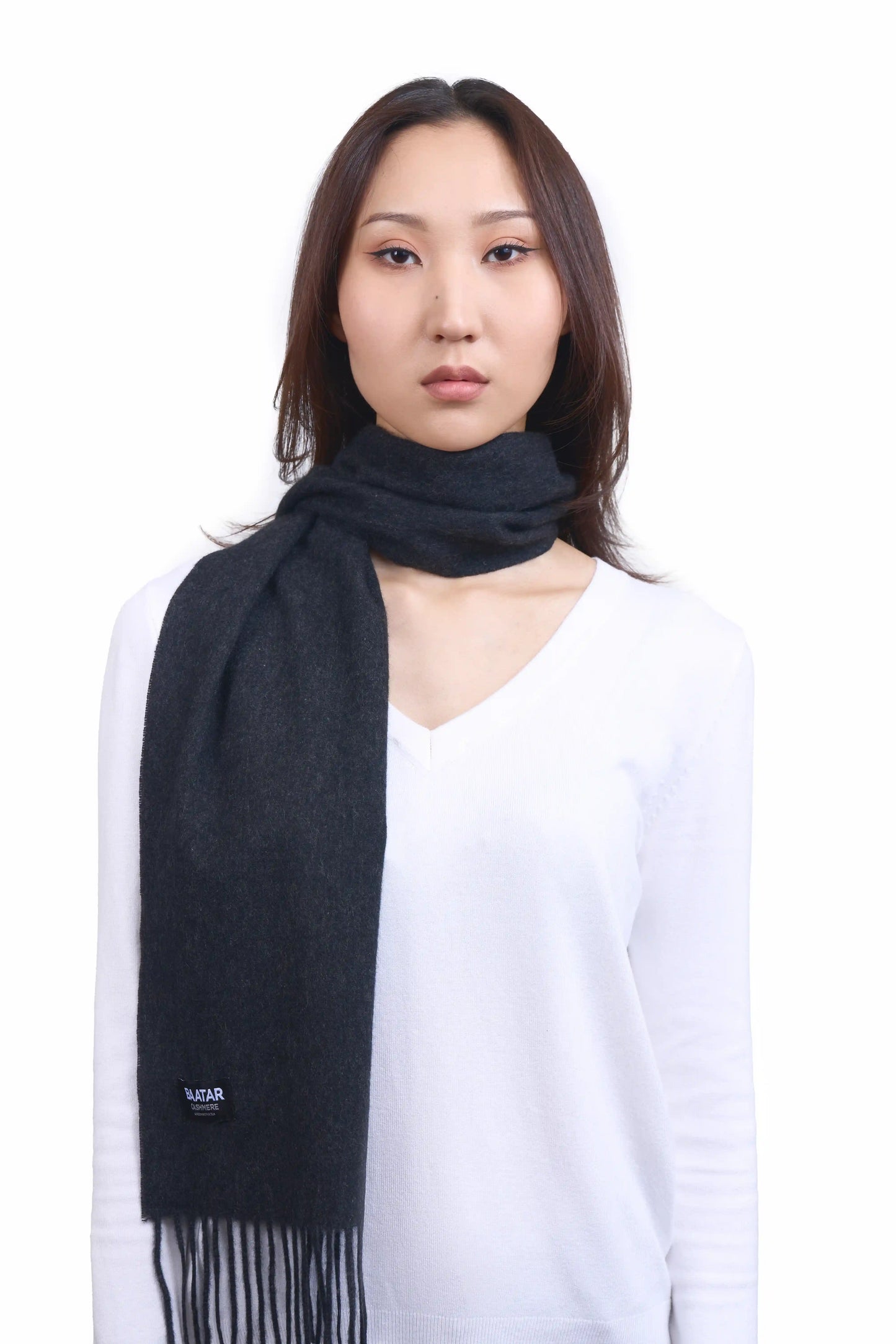 Luxurious charcoal gray Mongolian cashmere scarf worn on a female Mongolian model, lightweight and cozy, perfect for winter layering