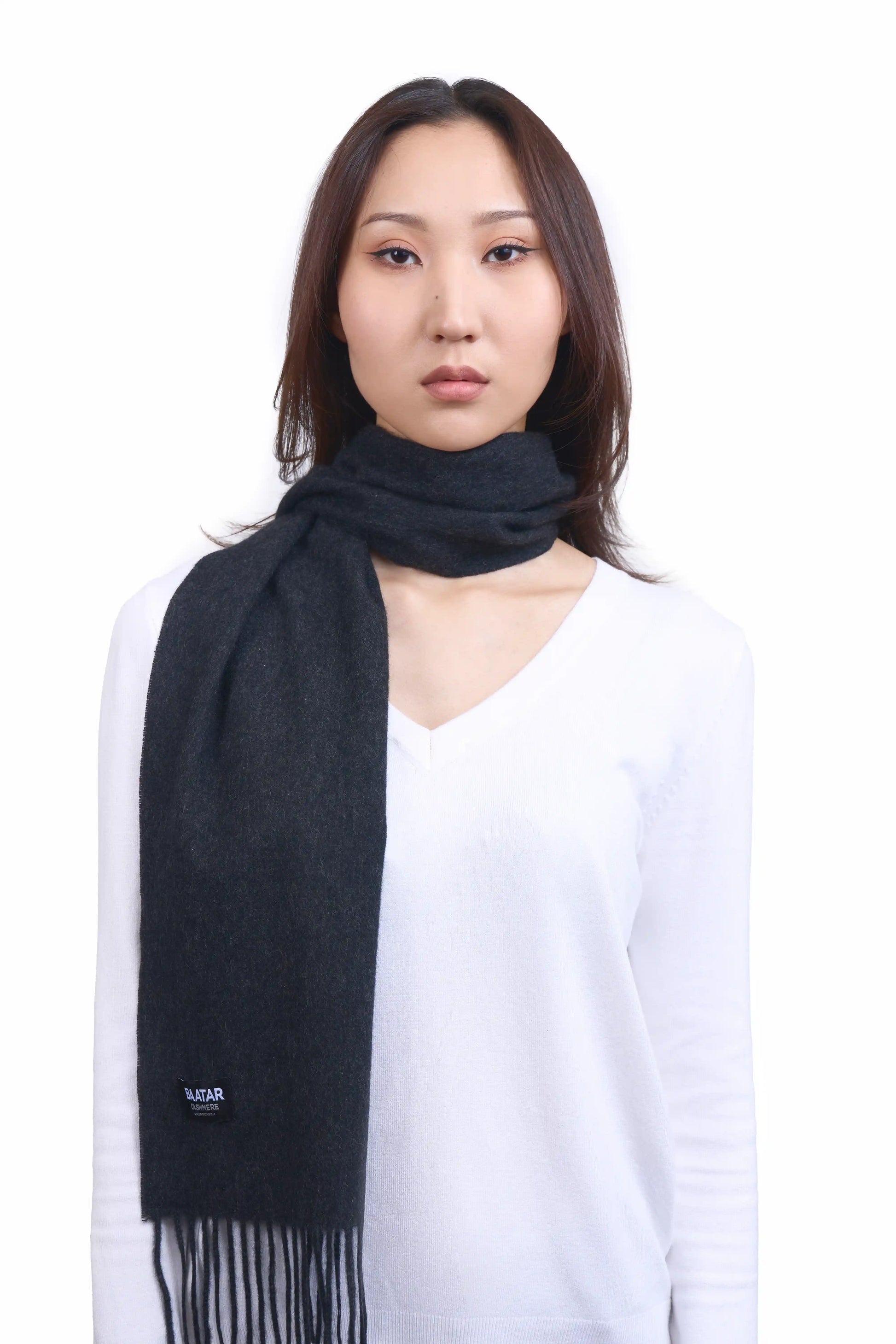 Luxurious charcoal gray Mongolian cashmere scarf worn on a female Mongolian model, lightweight and cozy, perfect for winter layering