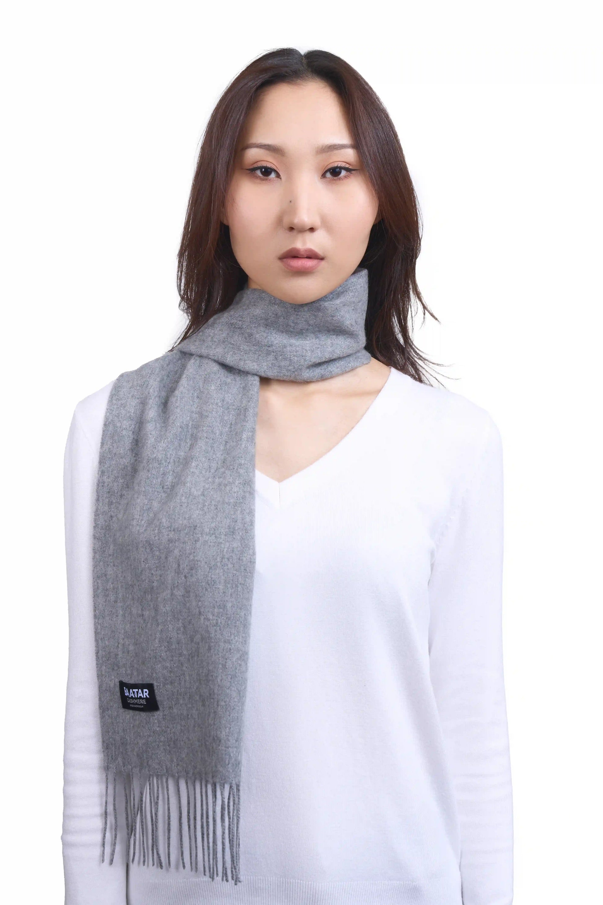 Luxurious light gray Mongolian cashmere scarf worn on a female Mongolian model, lightweight and cozy, perfect for winter layering